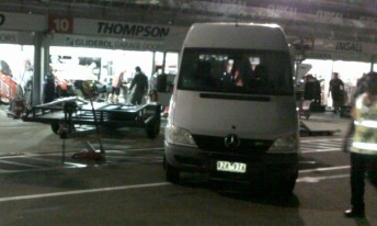 thommo garage A van and trailer pick up the remains of Thompson's car last night to take it back to Melbourne