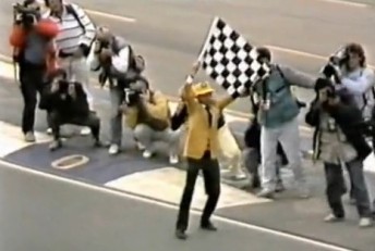 pic Here's something you don't see anymore. Not only is the flag waver on the track, but so is a horde of photographers!
