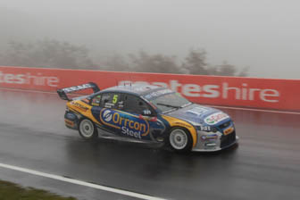 car Mark Winterbottom slides through the wet conditions at the top of the mountain