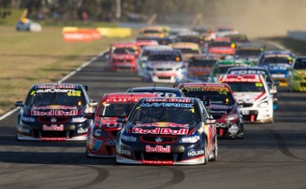 The field heads into Turn 3 on the opening lap