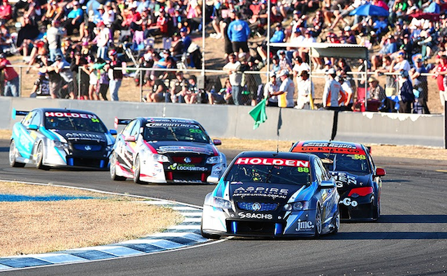 Paul Dumbrell leading Aaren Russell at Queensland Raceway
