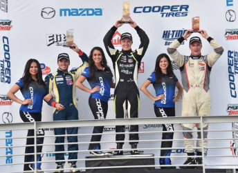 Parker Thompson (centre) celebrates victory in Race 1
